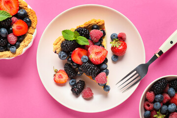Plate with delicious berry pie on pink background, closeup