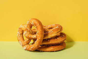 Tasty pretzels on color background, closeup