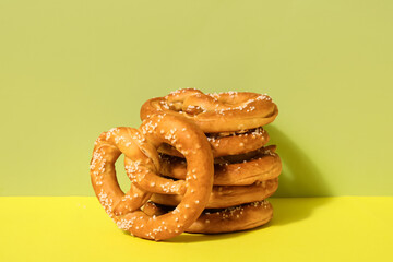 Tasty pretzels on color background, closeup