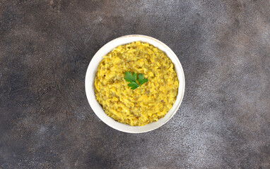 Indian khichri, kichri with rice, lentils and spices on grey background. Top view. Ayurvedic diet.