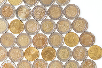Euro coins llie in rows on a white or black background, top view