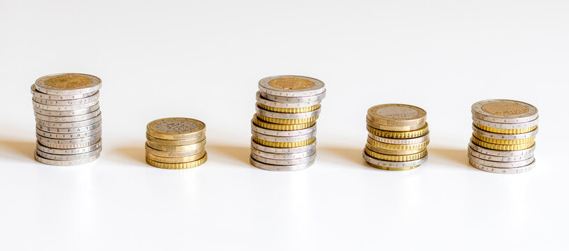 Stacks of euro coins on white background.