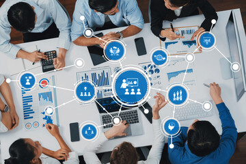 A dynamic business meeting showcasing professionals analyzing statistical charts and data on laptops, fostering collaboration for informed decision-making in a corporate setting. Amity