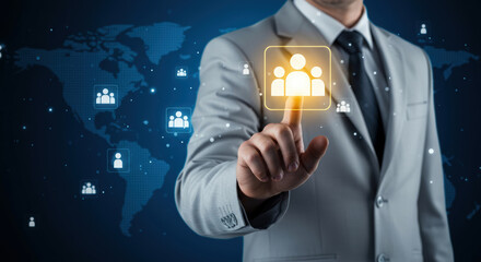 Businessman selecting holographic user group icon over world map background. Concept of global networking, communication and digital community
