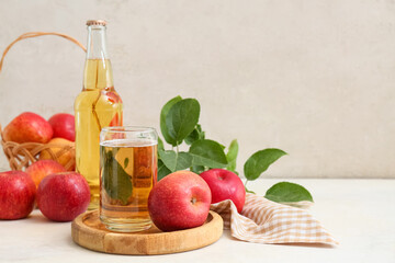 Glass and bottle of fresh apple cider with fruits on white background