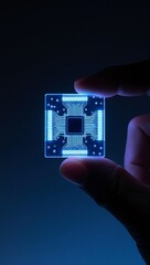 Macro shot of a glowing quantum photonics chip held between fingers, showcasing advanced technology.