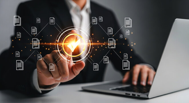 Person interacting with digital documents and a laptop in a modern office environment setup