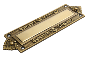 Close-up shot of an antique brass doorplate isolated on a white background, featuring intricate floral designs and a rectangular plate for engraving