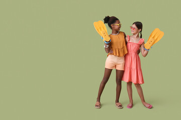 Cute little girls with flippers on green background © Pixel-Shot