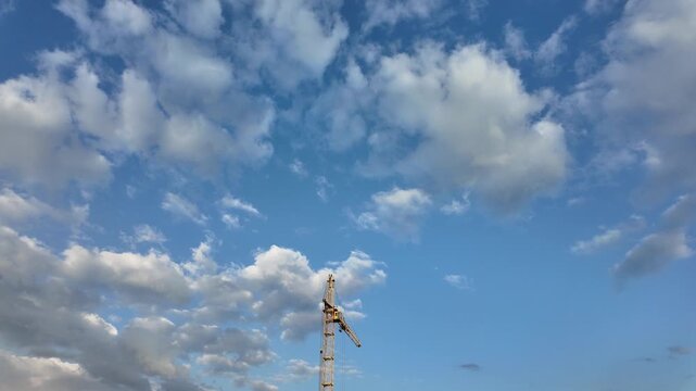 Timelapse of an industrial construction crane with cloudy background
