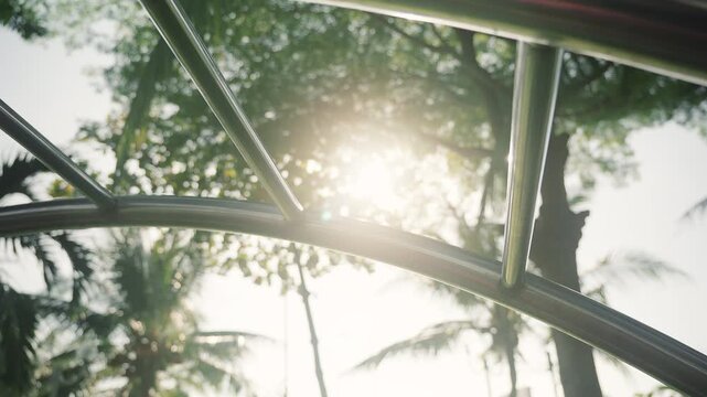sun shines through the trees onto a metal outdoor workout area. Close up Vertical Ladder for Outdoor Sport