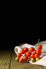 Cherry Tomatoes on Rustic Linen and Wooden Surface &ndash; Black Background