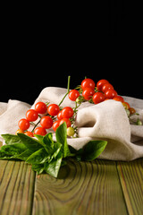 Natural Still Life of Tomatoes on Fabric and Wood with Black Background