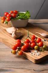 Still Life with Tomatoes, Wooden Board, and Linen on Black Background