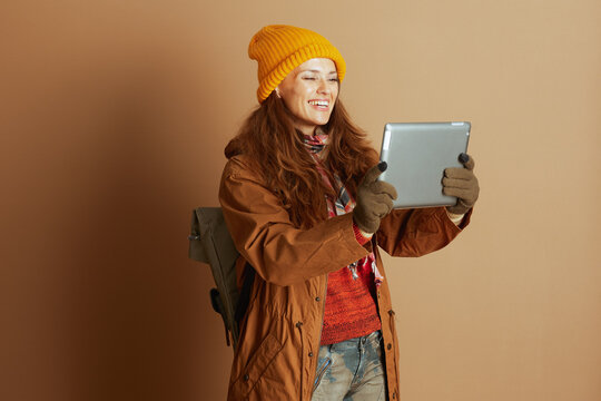 Smiling Hiker with Tablet and Camouflage Jeans