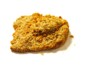 Fine breaded chicken breast fillet on white background. Classic poultry product. Uncooked meat covered with golden breadcrumbs.