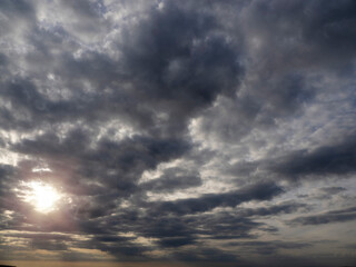 Dark and dramatic cloudy sky with sun beams. Nature background for design.