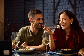 Young happy couple enjoying in lunch in restaurant.