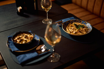 Italian dishes served with a glass of wine in a restaurant.