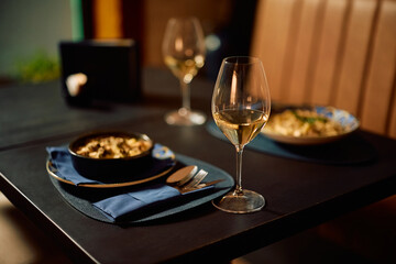 A glass of white wine served during a lunch in restaurant.