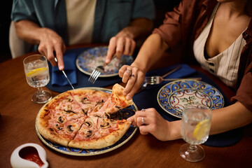 Close up of eating pizza in a restaurant.