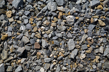 Gravel stones forming a rough surface. Natural rocks in different shades and shapes.