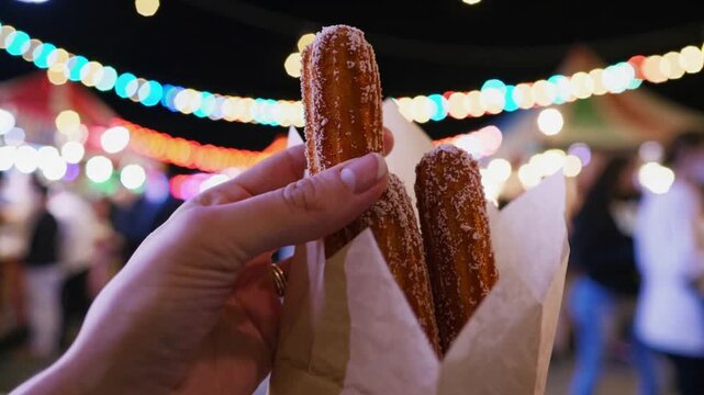 Enjoying delicious churros at a vibrant night market filled with lights and excitement in your city