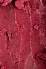 Close-up texture of rich red berry sorbet, vibrant and refreshing frozen dessert background