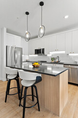 Kitchen with a counter and two chairs