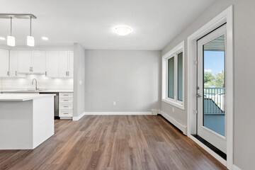 Large open kitchen with a white island and a large window