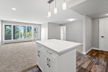 Large open kitchen with a white island and a light fixture above it