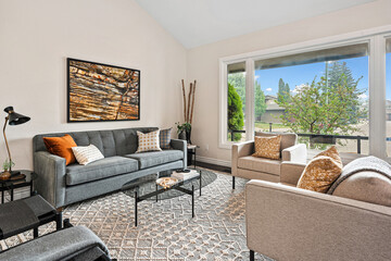 Living room with a large window and a painting on the wall