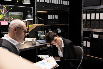 Team of skilled detectives reviewing intelligence from classified records, linking clues across...