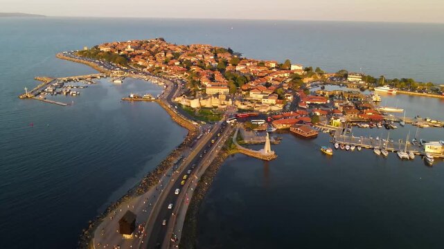 Aerial view of old mill, road and the center of old Nessebar, houses, churches. Drone view from above. Summer holidays destination
