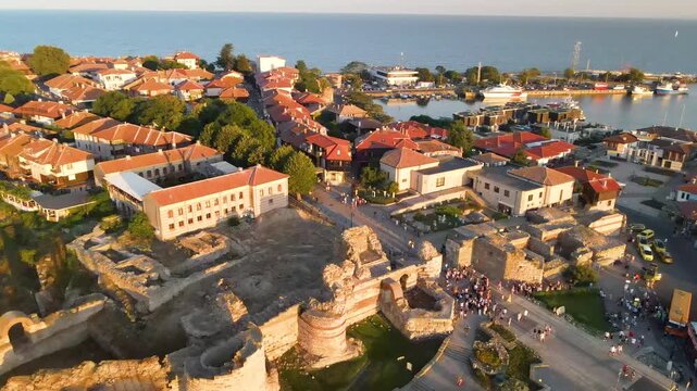 Nessebar old town and road with mill. Old houses and churches in old city of Nessebar near city in Bulgaria. Drone view from above. Summer holidays destination
