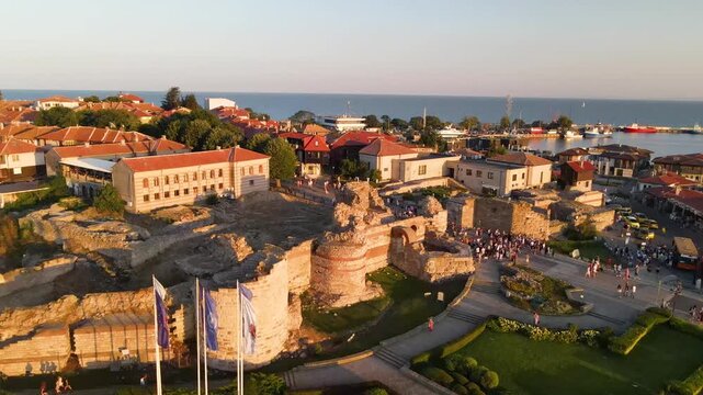 Nessebar old town and road with mill. Old houses and churches in old city of Nessebar near city in Bulgaria. Drone view from above. Summer holidays destination
