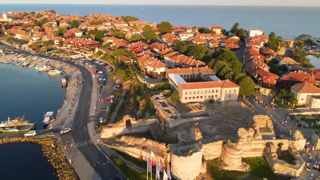 Nessebar old town and road with mill. Old houses and churches in old city of Nessebar near city in Bulgaria. Drone view from above. Summer holidays destination
