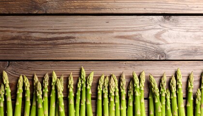 Fresh asparagus spears arranged on a wooden surface