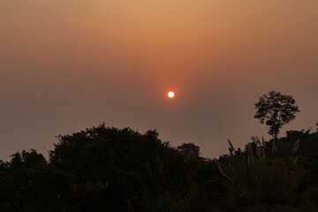 Spectacular sunrise over green mountain slopes in the serene Sajek Valley area.