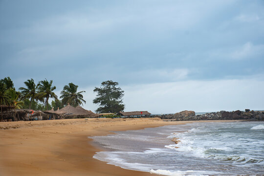 tropical beach with palm trees, San Pedro beach with coconut trees and traditional beach huts