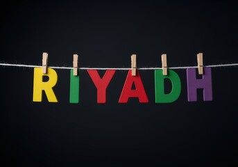 Colorful Riyadh letters hanging on a string