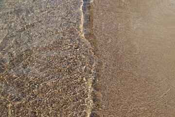 Clear water and sand on a beach. Water background with sand. Natural and fresh and environment. Natural Background.