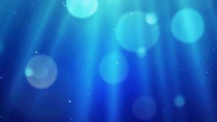 Dreamy blue underwater light rays shimmering with bokeh circles creating peaceful ocean vibe