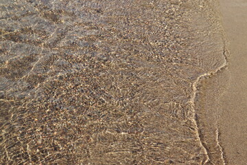 Clear water and sand on a beach. Water background with sand. Natural and fresh and environment. Natural Background.