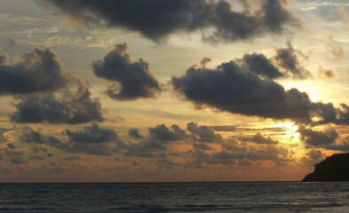Amazing bright sunset on the beach in Thailand. Beautiful clouds sky over the sea