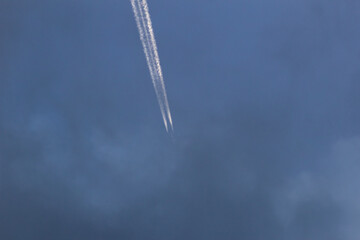 Airplane in the blue sky with white clouds. 