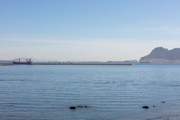 Strait of Gibraltar beach with Gibraltar Rock in view. Gibraltar, Spain. September 2025.