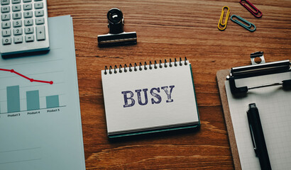 There is notebook with the word BUSY. It is as an eye-catching image.