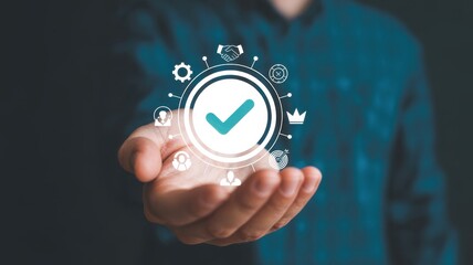 Obraz premium Hand holding a check mark icon, symbolizing quality assurance, guarantee, and standard compliance in business and service