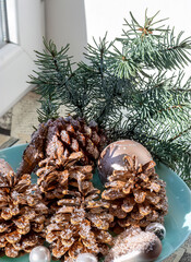Obraz premium Christmas decoration with pine cone, branch. New Year ornament for winter holiday season decor. Traditional festive celebration.